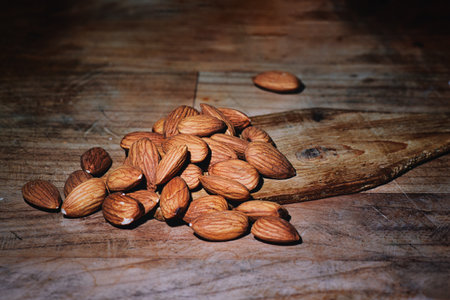 Some almonds in scoop on wood