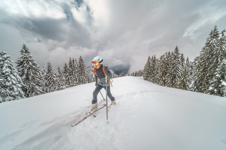 Child while climbing on skis in sealskins drinking cold water
