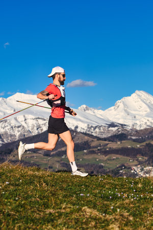 Sporty man practicing Nordic walking in the hills alone