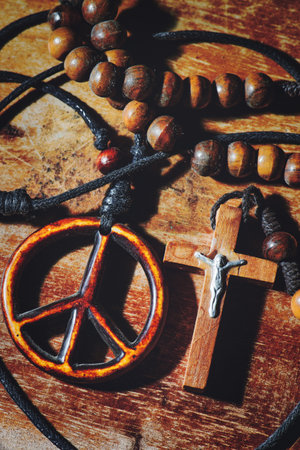 Symbol of peace and the Crucifix on wooden table