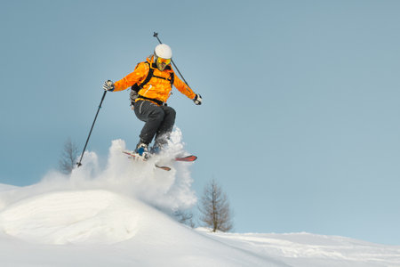 A skier during a jump in fresh snowの写真素材