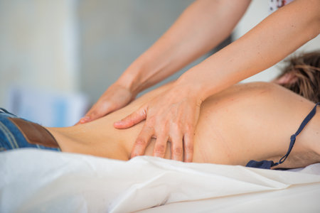 Back massage by a specialist masseurの写真素材