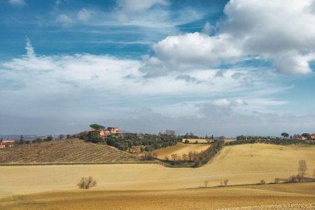 A landscape with typical Tuscan Italy farmhouseの写真素材