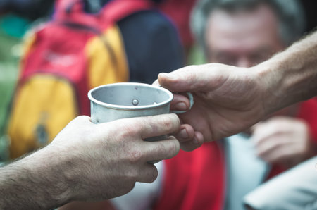 Exchange of chalice of tin between two handsの写真素材