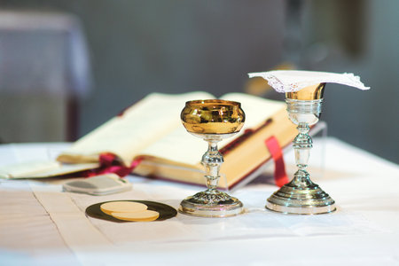 Chalice and consecrated host part for Eucharist in churchの写真素材