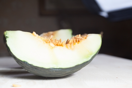 Green melon on a wooden table