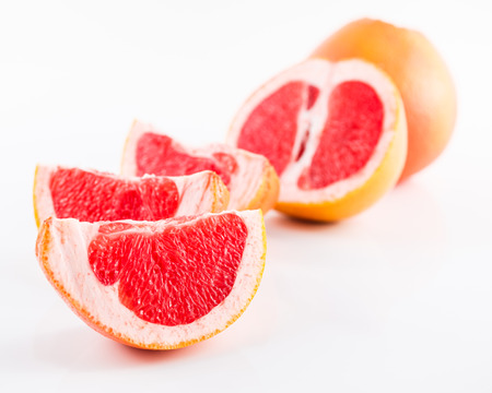 Slice grapefruit isolated on white backgroundの写真素材
