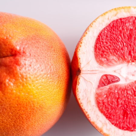 Slice grapefruit isolated on white backgroundの写真素材