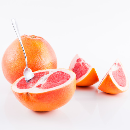 Slice grapefruit isolated on white backgroundの写真素材