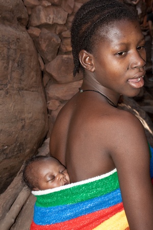 January 1, 2010 - Mali (west Africa): Young mother with baby. Typical African baby carrier.のeditorial素材