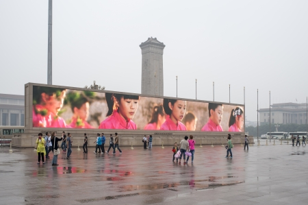 PIAZZA TIENANMEN, BEIJING - CIRCA 2013: People watching spot on  mega-screen in Tienanmen squareのeditorial素材