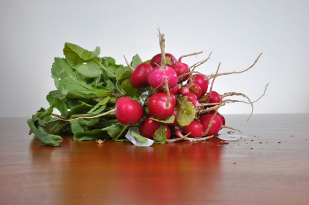 fresh radishes on a wooden boardの写真素材