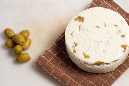 homemade cheese with olives against white backgroundの写真素材