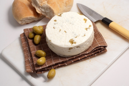 homemade cheese with olives against white backgroundの写真素材