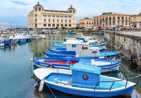 Syracuse, Sicily / Italy - June 18 2017: boats in the dock and Ortea Palace Luxury Hotelのeditorial素材