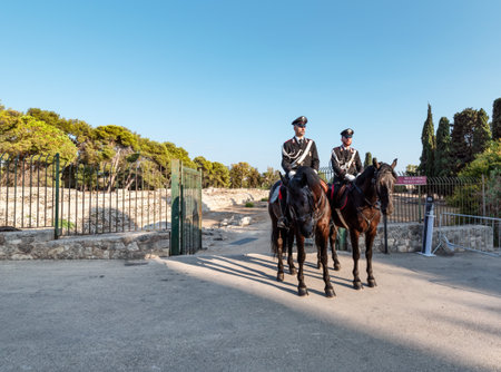 Syracuse Sicily Italy - july 22 2021: Two proud carabinieri on horseback inside the archaeological park of Neapolisのeditorial素材