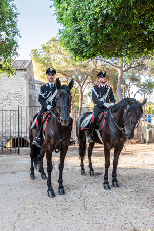 Syracuse Sicily Italy - july 22 2021: Two proud carabinieri on horseback inside the archaeological park of Neapolisのeditorial素材