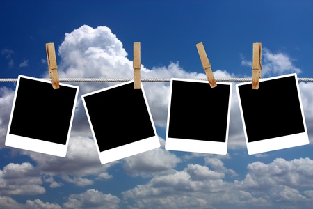 Four pictures hanging on the rope with clothespinsの写真素材