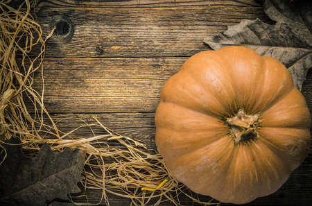 Pumpkin on wooden table leaves and straw # 3の写真素材