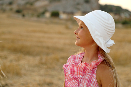 Portrait of little girl in a hay field # 2の写真素材