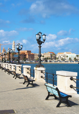 Seafront promenade with benches and old town in the background in Bari, Puglia, Italyの写真素材
