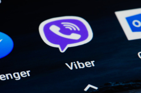 Viber icon on smartphone. App for chat, call and message, cross-platform instant messaging and voice...