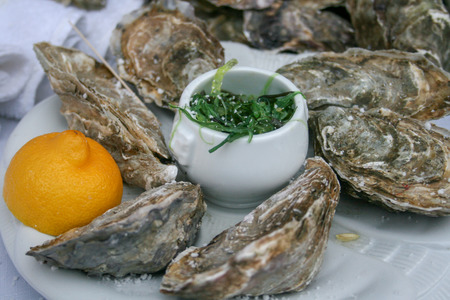 Group of closed oysters with lemon