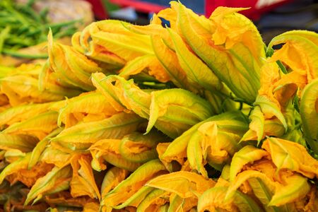 Fresh courgettes flower or courgettes in a farmer agricultural open air market, seasonal healthy food. Concept of biological, bio products, bio ecology, grown by yourself, vegetariansの写真素材