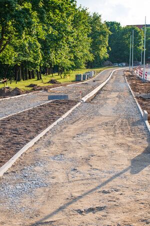 Building a new bike path with sidewalk, bicycle road under construction, verticalの写真素材