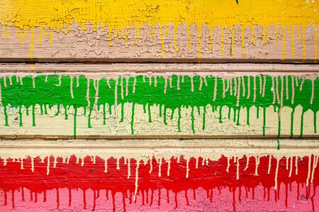 Colorful wooden background of peeling cracked surface. Abstract pattern in rustic style. Dripping paintの写真素材