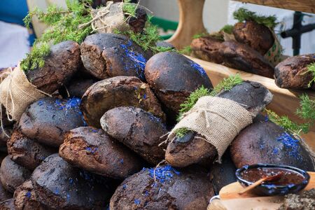 Homemade black cereal and juniper bread with hemp seeds in a traditional street food market