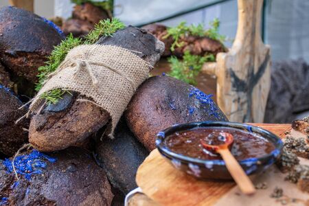 Homemade black cereal and juniper bread with hemp seeds in a traditional street food marketの写真素材