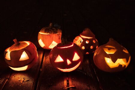 Spooky Halloween pumpkins, Jack O Lantern, with burning candlesの写真素材