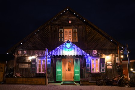 Typical traditional old wooden restaurant in Trakai, Vilnius, Lithuania, night view with colorful lightsのeditorial素材