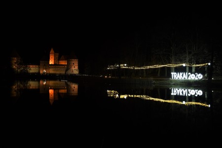 Logo of Trakai, Lithuanian capital of Culture 2020, reflections on the water, night