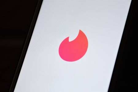 Close up view of Tinder, location-based social search mobile app and Web application most often used as a dating serviceのeditorial素材
