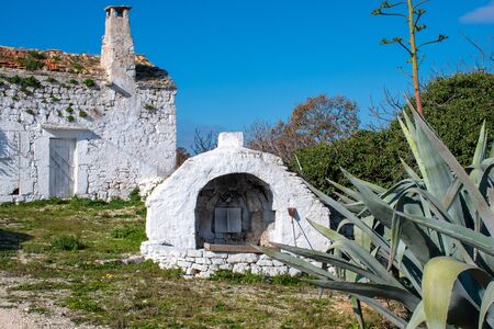 Ancient old stone oven in a countryside village in Puglia, Italy, Europe with agave plantのeditorial素材