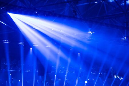 Scene, stage lights with colored spotlights and smoke, beams of lights background, white and blue