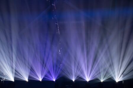 Scene, stage lights with colored spotlights and smoke, beams of lights background, white and blueの写真素材