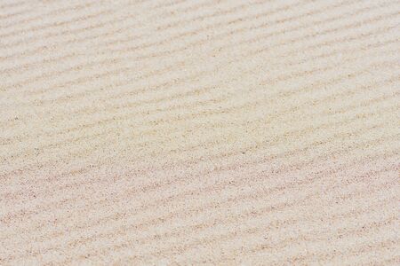 Beautiful sand background with waves created by grains. Summer, holiday or vacations conceptの写真素材