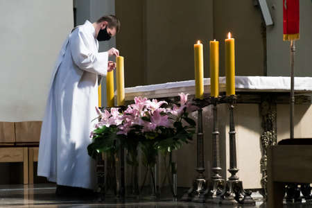 Vilnius, Lithuania - May 23 2020: Priest with protective face mask in a church during Covid or Coronavirus emergency, reopening churchのeditorial素材