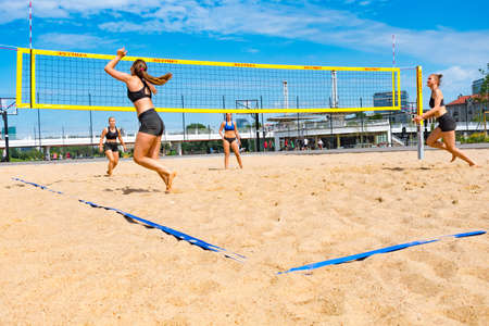 Girls playing beach volleyball in summer in the cityの写真素材