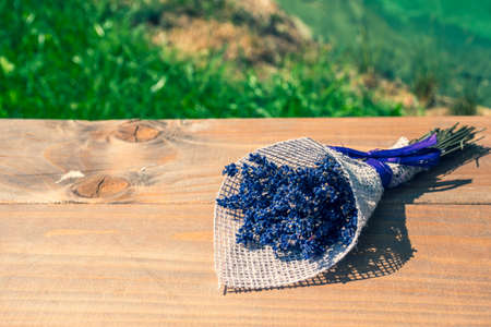 Beautiful bunch or bouquet of lavender flowers on a wooden table