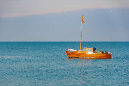 Old wooden vintage boat on the lagoon in Nida, Lithuaniaの写真素材