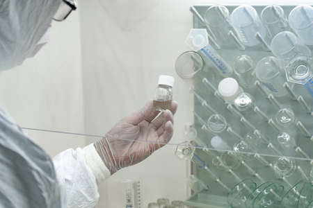 Medical test vaccine research and development concept. Scientist in laboratory studying and...