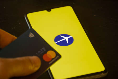 Vilnius, Lithuania - November 12 2020: Expedia logo displayed on the smartphone with credit card, travel and hotel industry crisis due to Covid or Coronavirus pandemic, data breachのeditorial素材