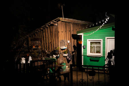 Old Lithuanian traditional wooden and stone green house, night background after the rain in Trakai,...
