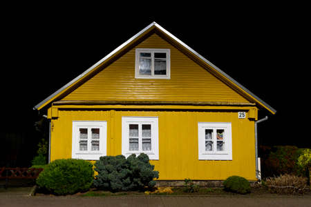 Old Lithuanian traditional wooden and stone yellow house, night background after the rain in Trakai, Vilnius, Lithuania, Europeの写真素材