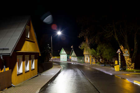 Old Lithuanian traditional wooden and stone houses, night background after the rainの写真素材