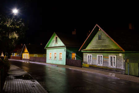 Old Lithuanian traditional wooden and stone houses, night background after the rainの写真素材